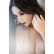 5ft 3in 159cm curvy Asian TPE sex doll with long wavy black hair, fair sking and large E-cup breasts in see through lingerie.