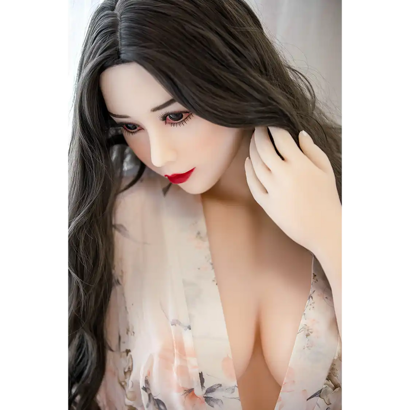5ft 3in 159cm curvy Asian TPE sex doll with long wavy black hair, fair sking and large E-cup breasts in see through lingerie.