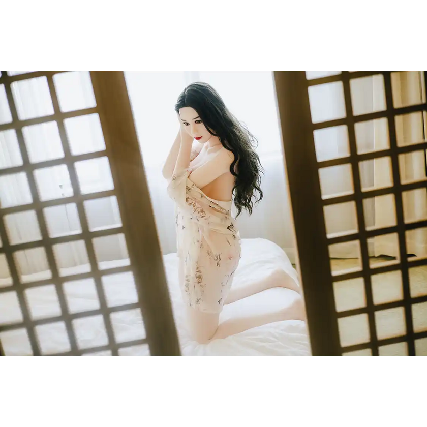 5ft 3in 159cm curvy Asian TPE sex doll with long wavy black hair, fair sking and large E-cup breasts in see through lingerie.