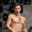 5ft 6in or 170cm silicone male sex doll with muscular arms, chest and abs with short brown hair and blue eyes in a country outfit.