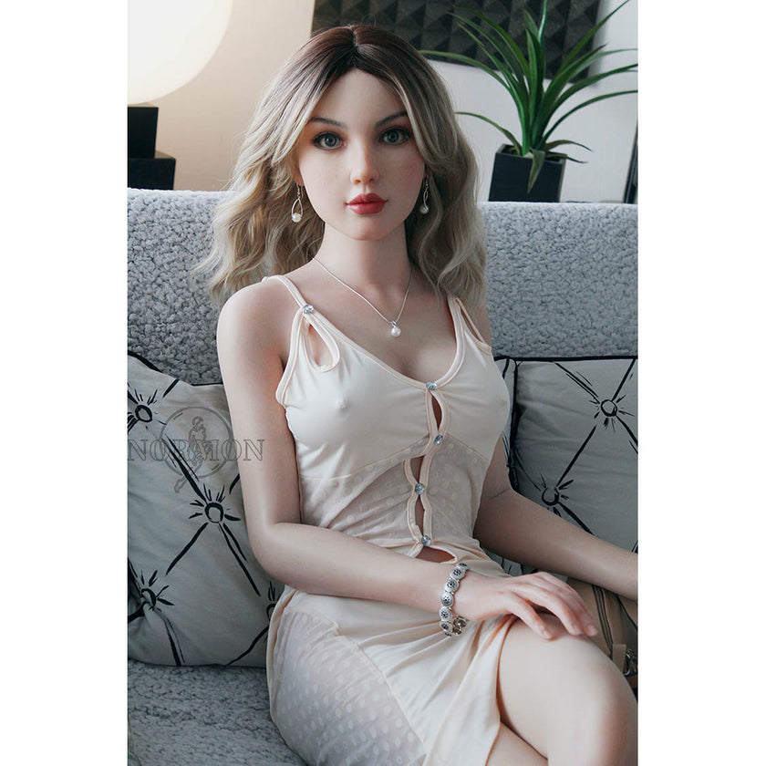 Tammy is a 5ft 5in or 165cm tall life size, lifelike, white female silicone sex doll with long legs, blue eyes, wavy blonde hair, very light skin, large perky breasts and a very slim athletic body.
