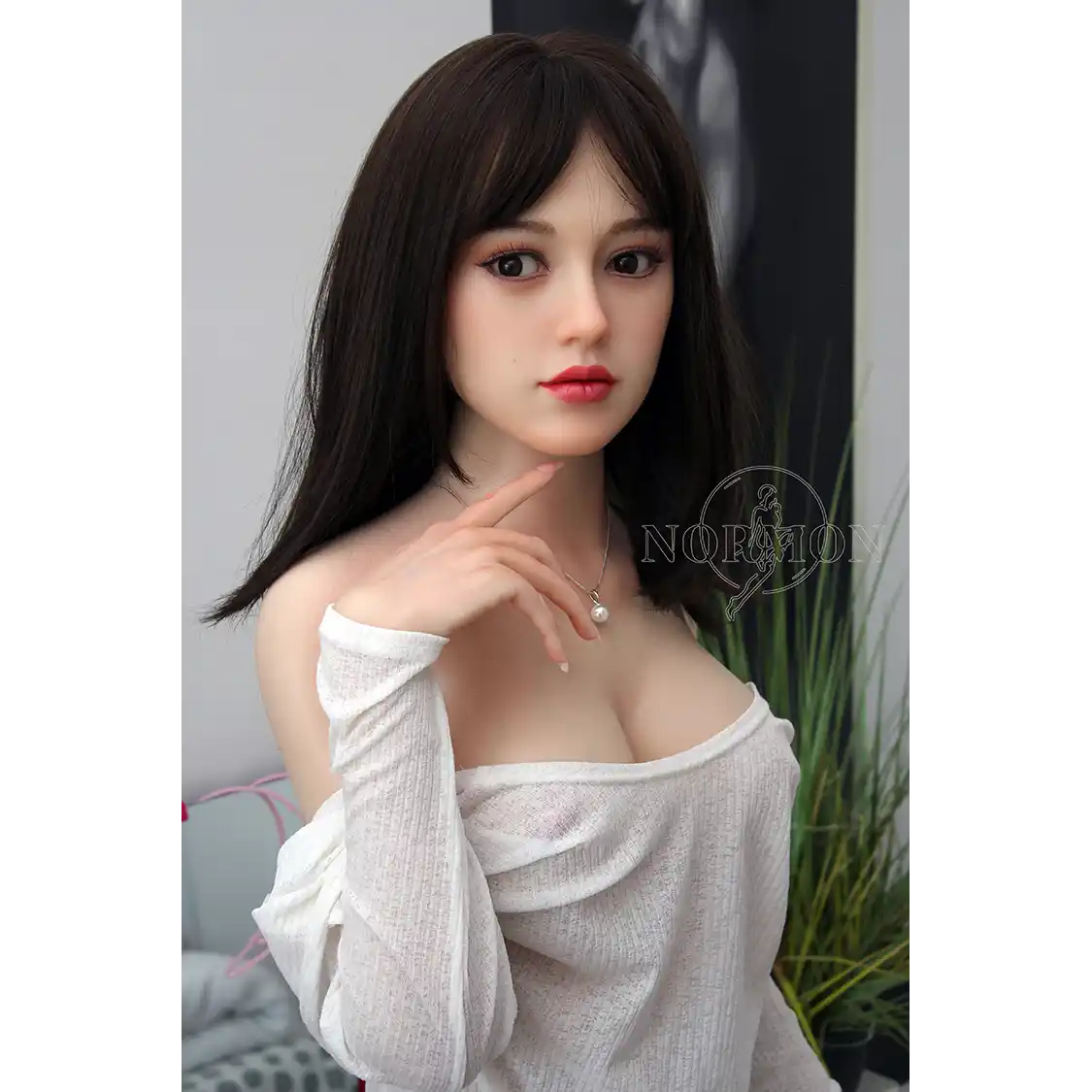 5ft 4in or 163cm tall life size, lifelike, silicone sex doll with long legs and long black hair in a sheer gray top.