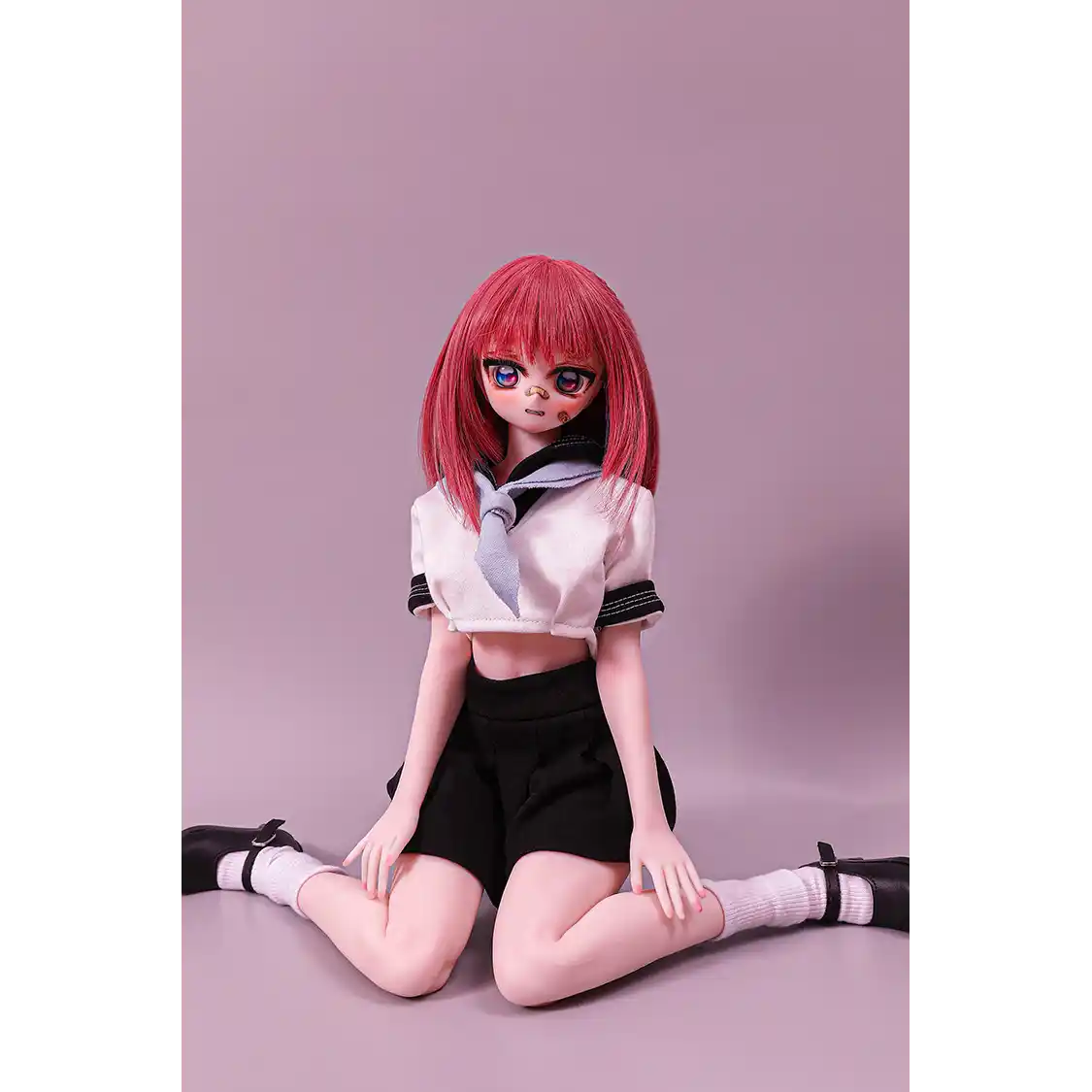 2ft 60cm anime style female mini silicone sex doll with medium breasts, fair skin and a fit athletic body in a school girl outfit.
