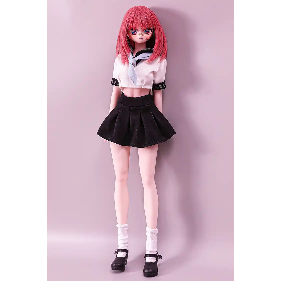 2ft 60cm anime style female mini silicone sex doll with medium breasts, fair skin and a fit athletic body in a school girl outfit.