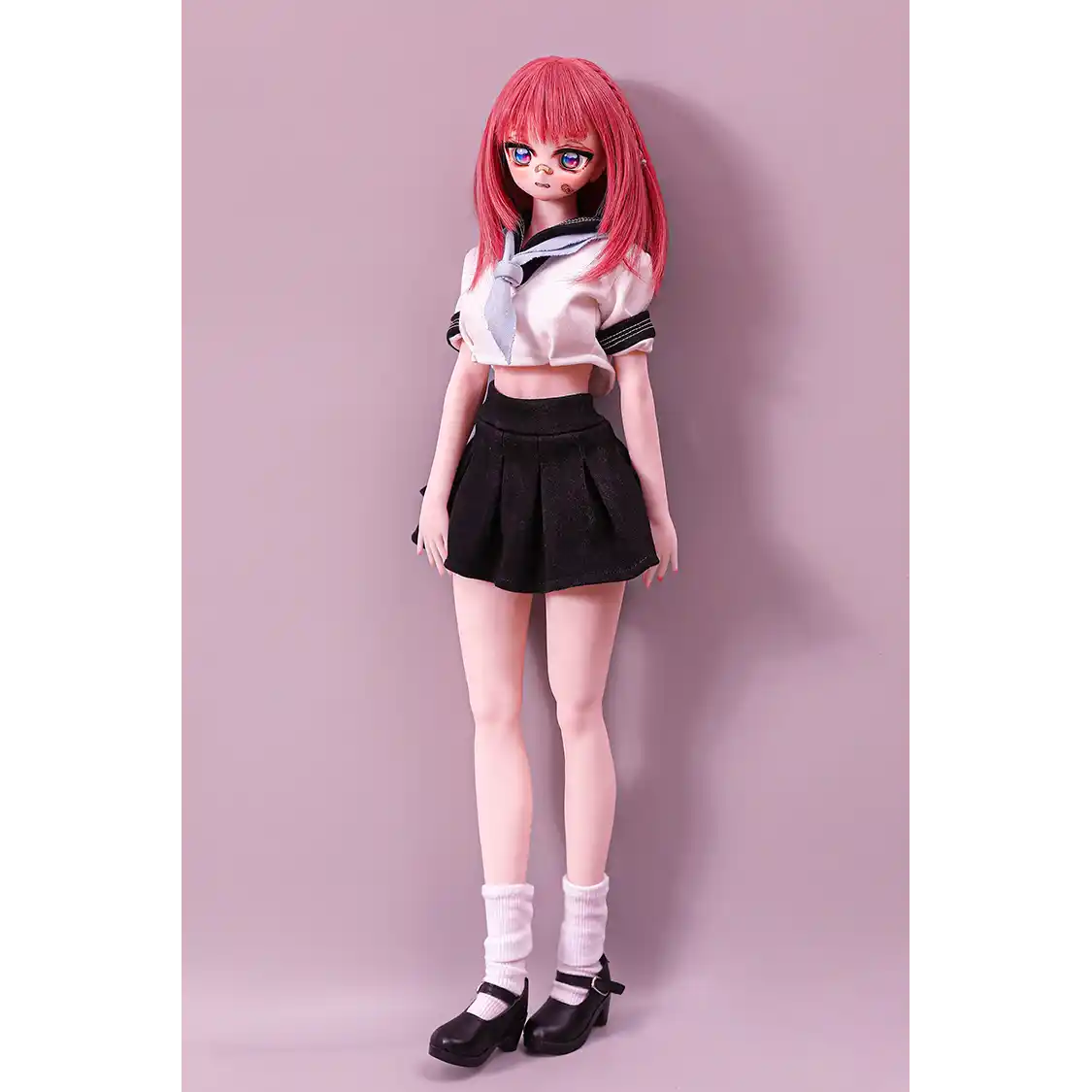 2ft 60cm anime style female mini silicone sex doll with medium breasts, fair skin and a fit athletic body in a school girl outfit.