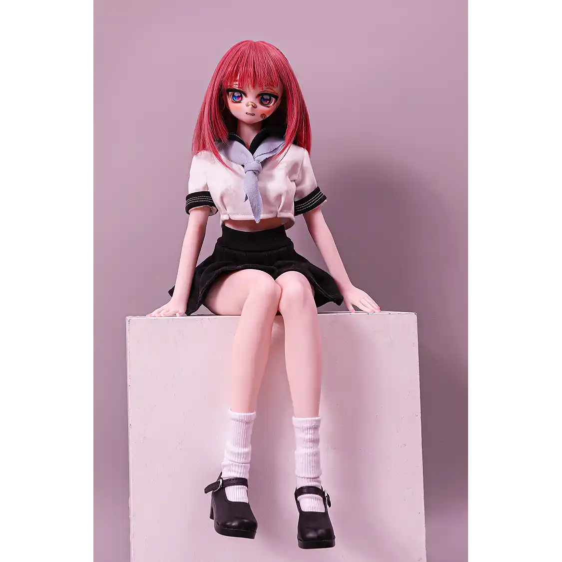 2ft 60cm anime style female mini silicone sex doll with medium breasts, fair skin and a fit athletic body in a school girl outfit.