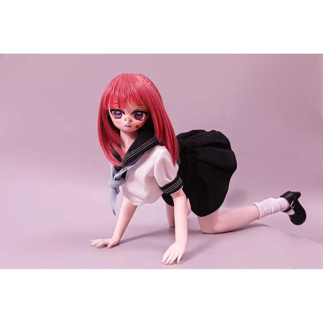 2ft 60cm anime style female mini silicone sex doll with medium breasts, fair skin and a fit athletic body in a school girl outfit.