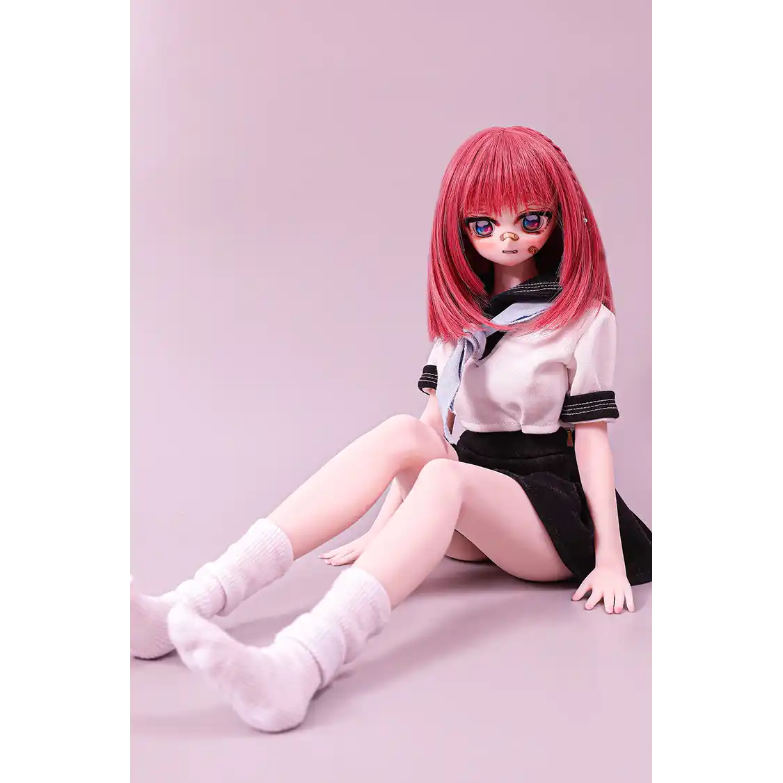 2ft 60cm anime style female mini silicone sex doll with medium breasts, fair skin and a fit athletic body in a school girl outfit.