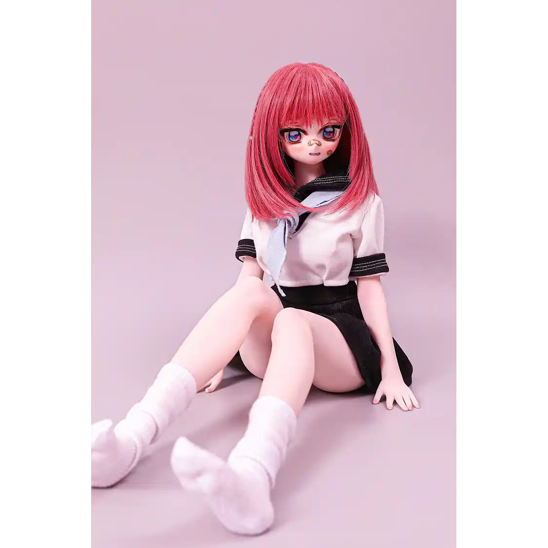2ft 60cm anime style female mini silicone sex doll with medium breasts, fair skin and a fit athletic body in a school girl outfit.