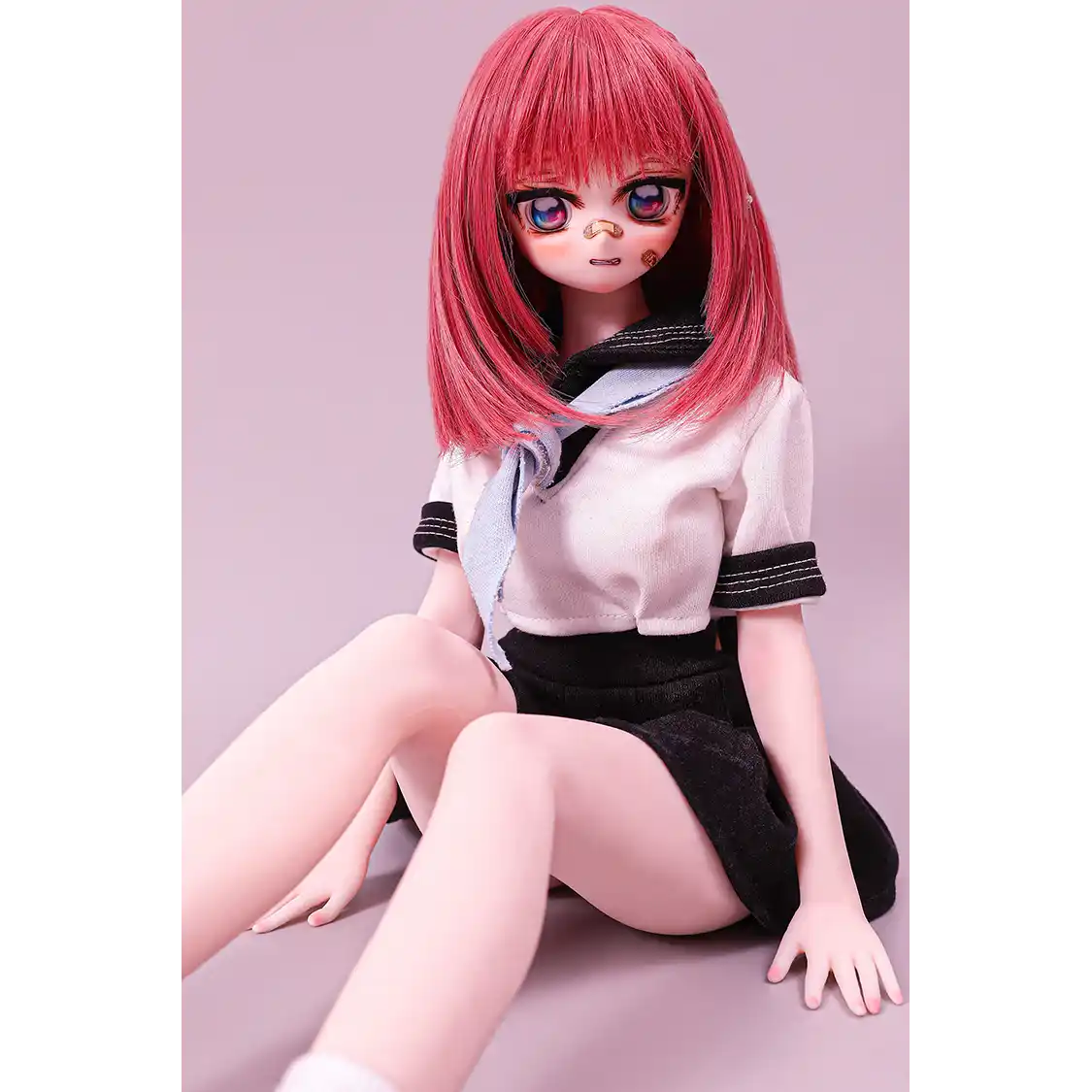 2ft 60cm anime style female mini silicone sex doll with medium breasts, fair skin and a fit athletic body in a school girl outfit.