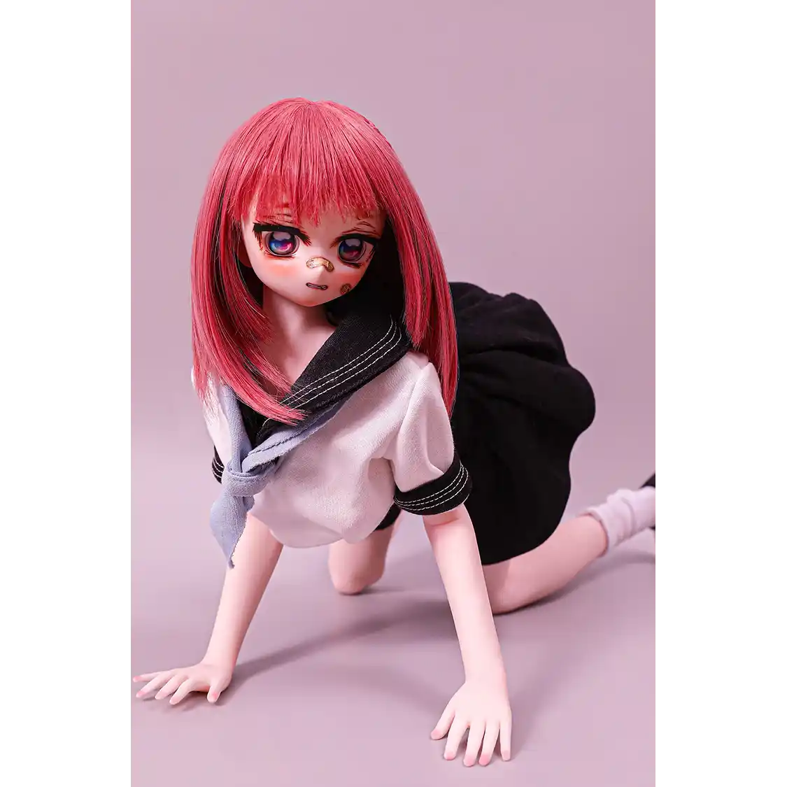2ft 60cm anime style female mini silicone sex doll with medium breasts, fair skin and a fit athletic body in a school girl outfit.