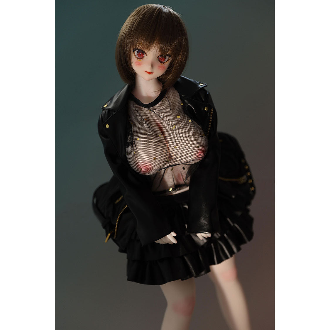2ft 60cm mini anime sex doll Zella. Silicone body construction, giant breasts, fair skin, short dark hair and a curvy body in a  sheer top, black leather jacket and black skirt.