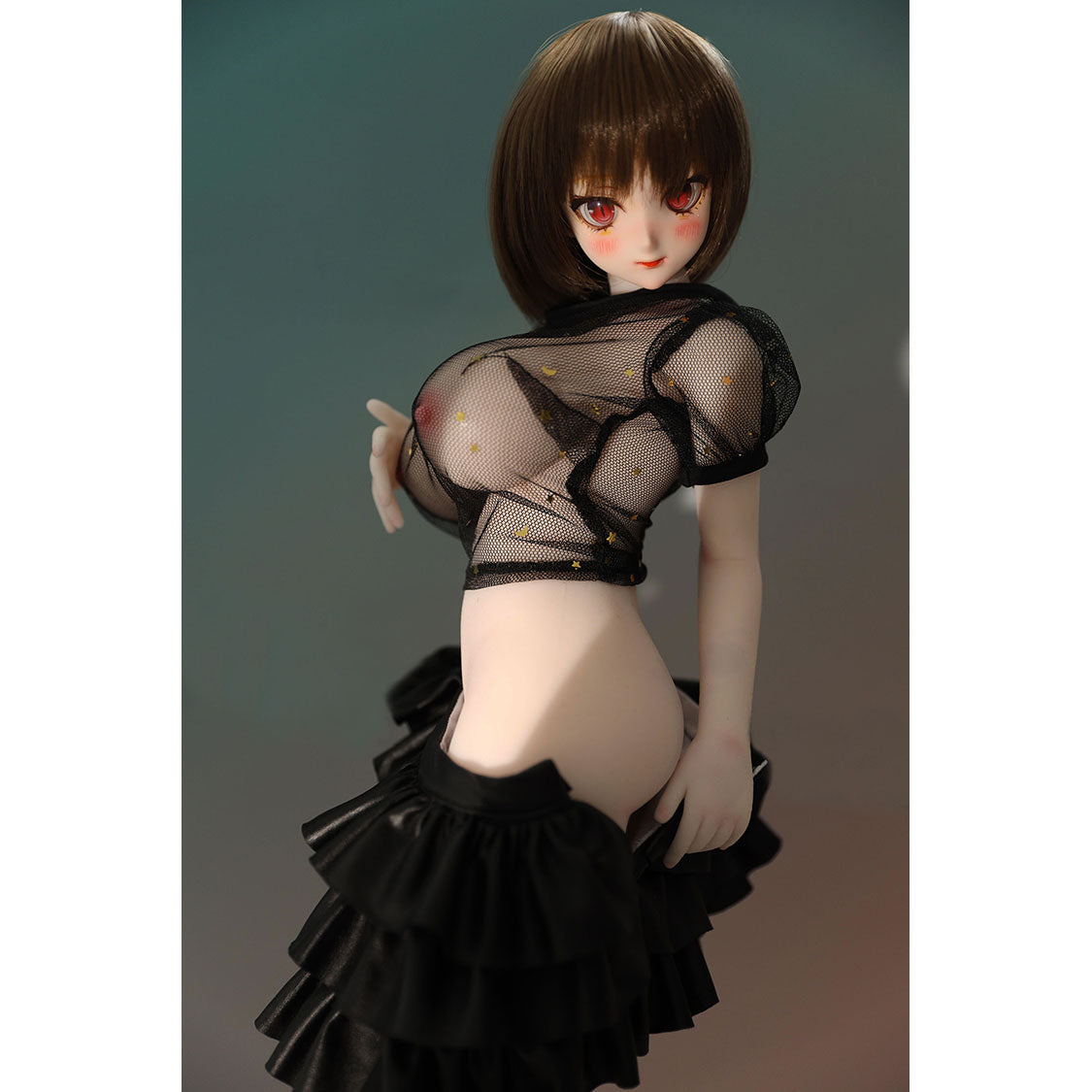 2ft 60cm mini anime sex doll Zella. Silicone body construction, giant breasts, fair skin, short dark hair and a curvy body in a  sheer top, black leather jacket and black skirt.