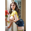 5ft 4in or 163cm tall life size hyper realistic silicone sex doll with long legs, very large breasts and long straight brown hair. Made by Normon Doll.