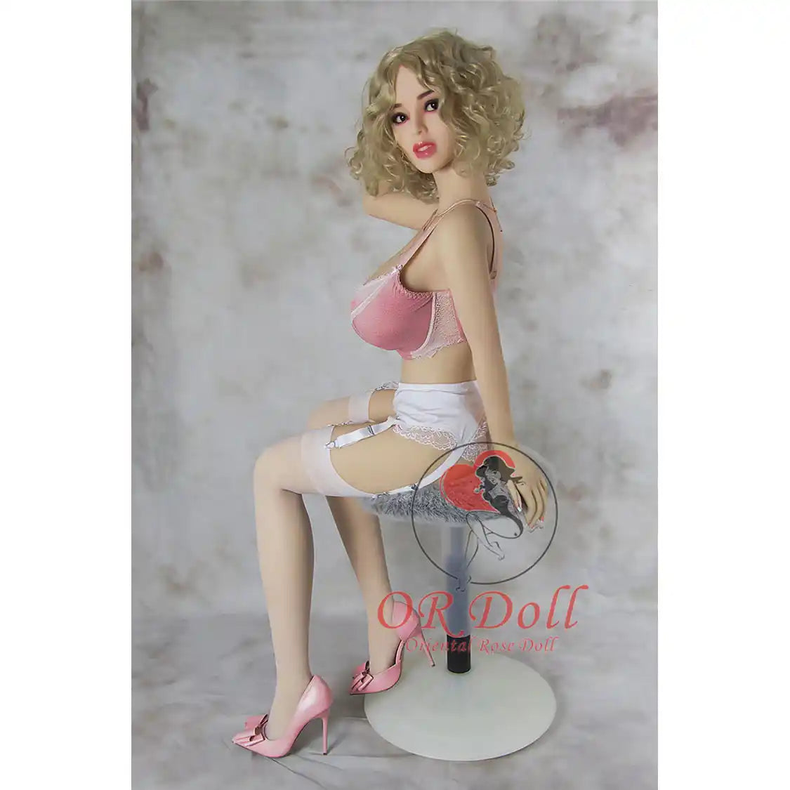 5ft 1in 156cm tall slim ultra life like TPE Sex doll with G cup breasts, mid length wavy blonde hair, bright red lipstick and brown eyes in lingerie.  By OR Doll.