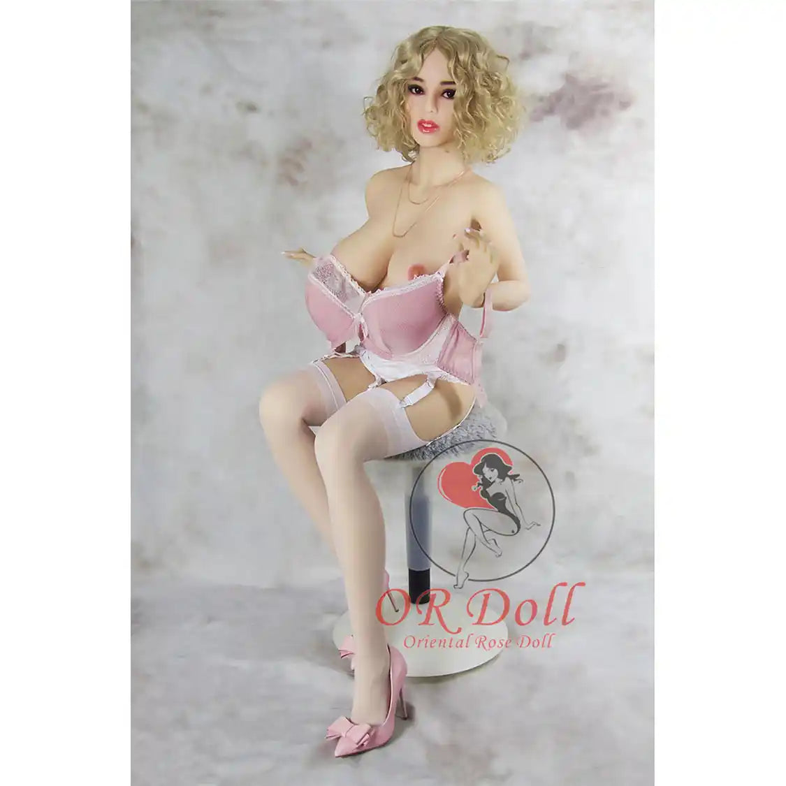 5ft 1in 156cm tall slim ultra life like TPE Sex doll with G cup breasts, mid length wavy blonde hair, bright red lipstick and brown eyes in lingerie.  By OR Doll.